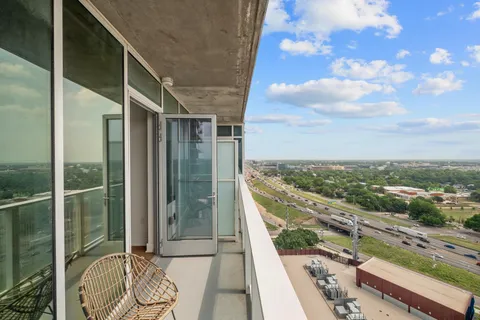 a view of balcony with floor to ceiling windows