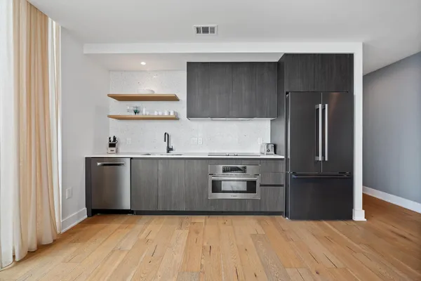 a kitchen with a refrigerator and a sink