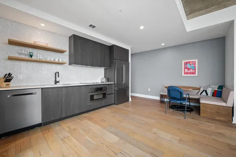 a kitchen with stainless steel appliances kitchen island granite countertop a sink and cabinets