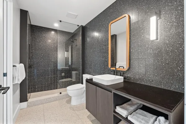 a bathroom with a double vanity sink toilet and shower