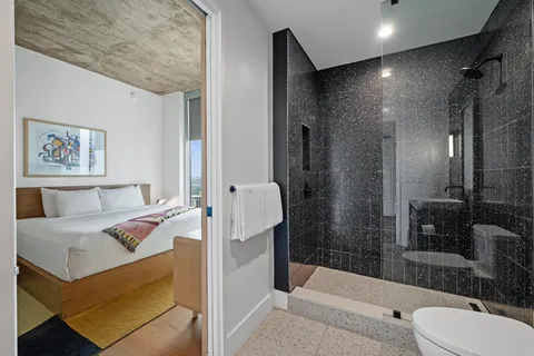 a bathroom with a tub toilet and shower