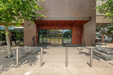 a patio with table and chairs and potted plants