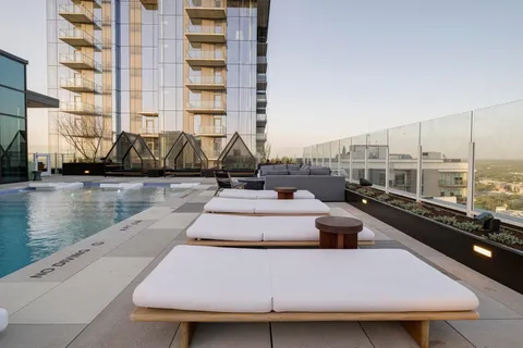 a view of swimming pool with outdoor seating and lake view