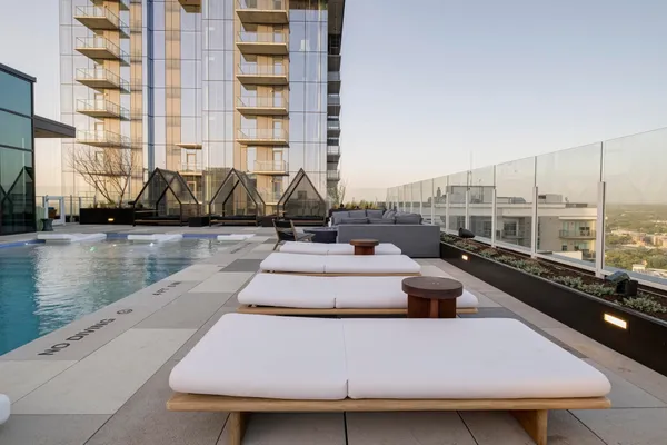 a view of swimming pool with outdoor seating and lake view