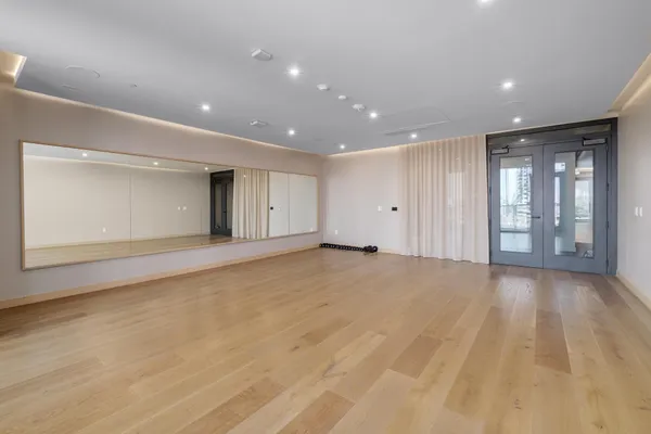 a view of an empty room with glass door