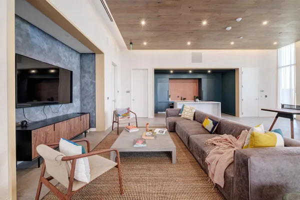 a living room with couches and a flat screen tv