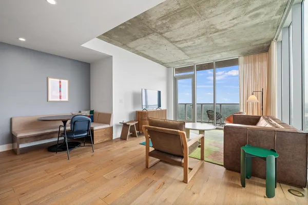 a living room with furniture and a wooden floor