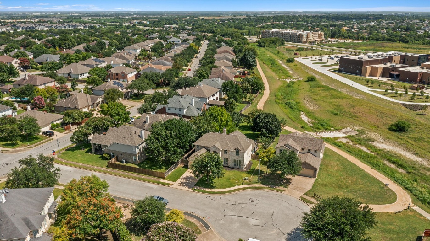 an aerial view of residential houses with outdoor space