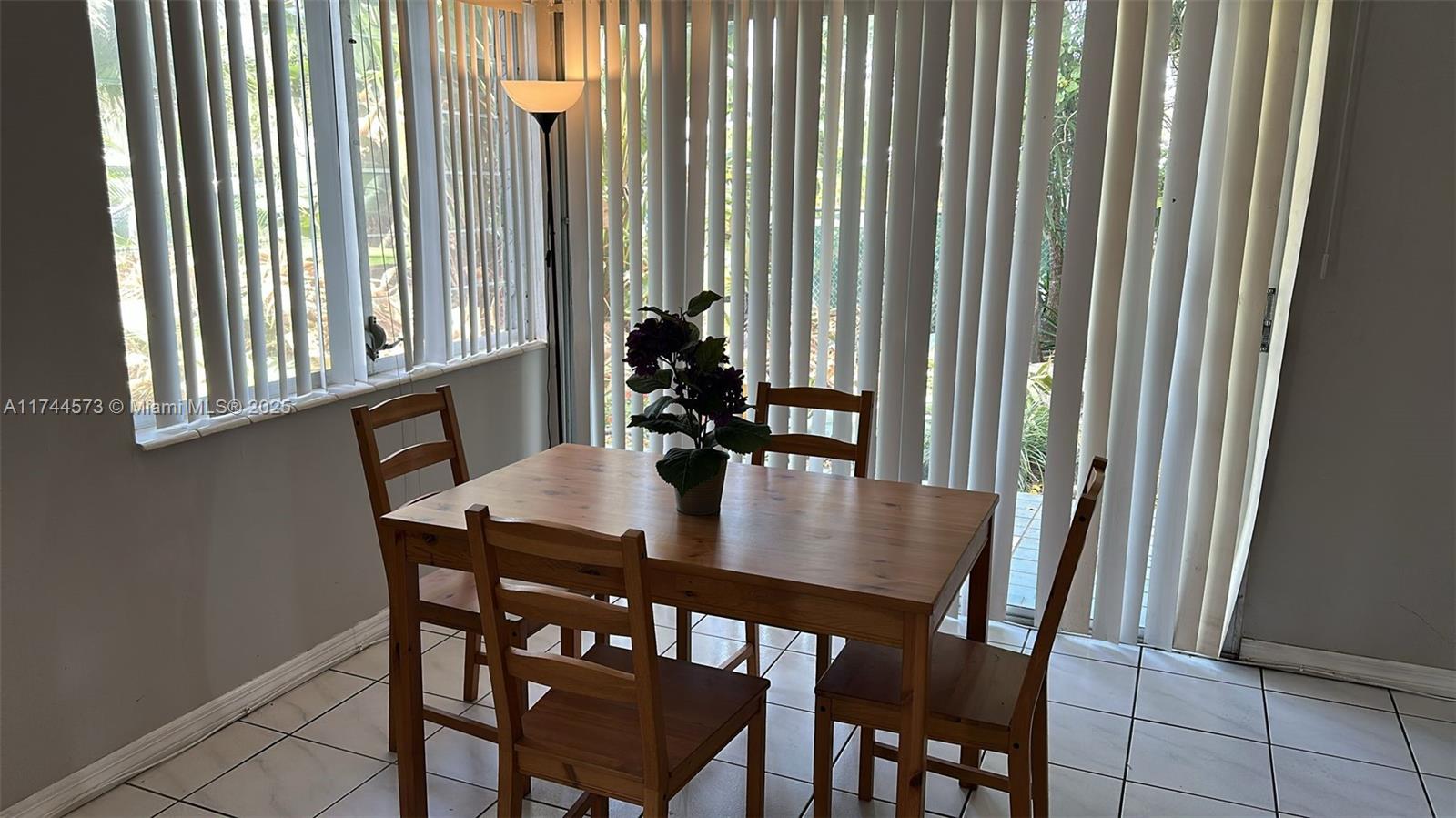 90 Isle Of Venice Drive, Unit 1 Fort Lauderdale, FL 33301 - Photo 3 of 7 a view of a dining room with furniture and a window