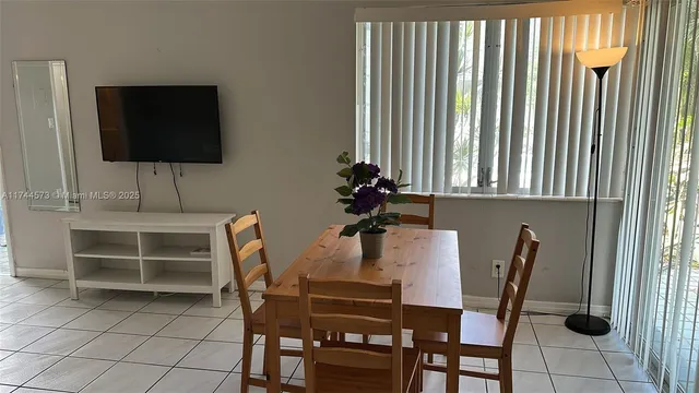 a dining room with furniture and window