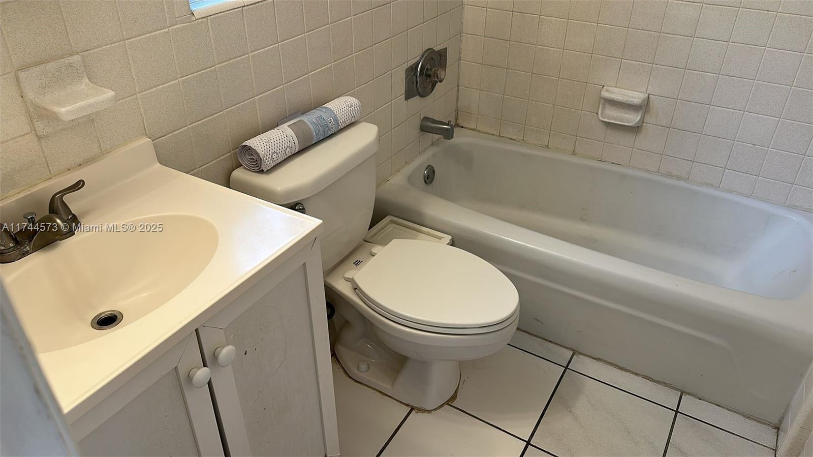90 Isle Of Venice Drive, Unit 1 Fort Lauderdale, FL 33301 - Photo 7 of 7 a bathroom with a sink a toilet and bathtub