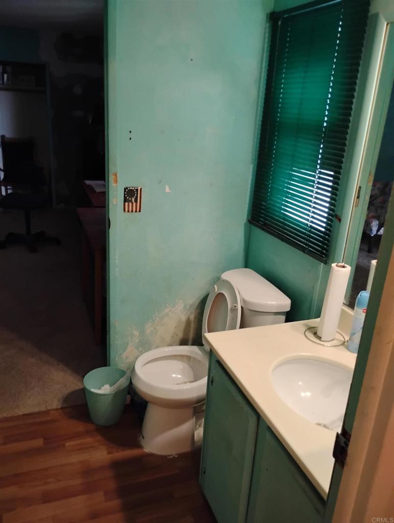 15181 Van Buren Boulevard, Unit 102 Riverside, CA 92504 - Photo 21 of 37 a bathroom with a toilet sink and mirror