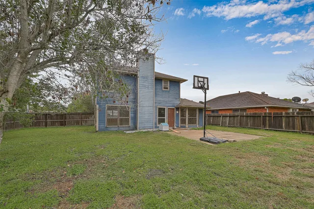a big house with a big yard and large trees