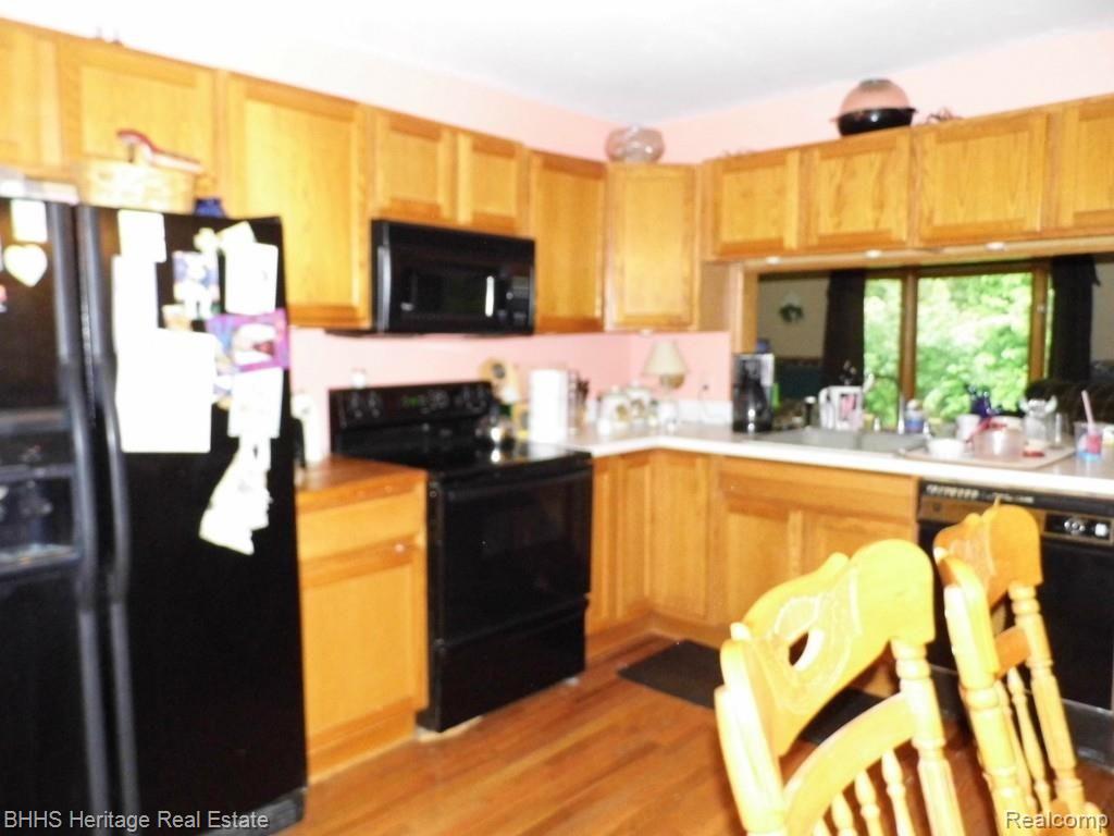 6950 West Sober Road Fowlerville, MI 48836 - Photo 25 of 32 Kitchen over looks family room