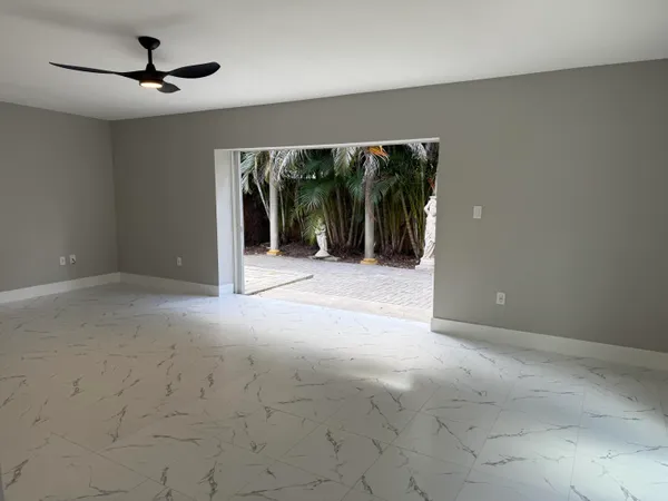 a view of a livingroom with a ceiling fan and window