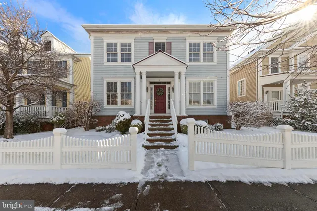 a front view of a house with a fence