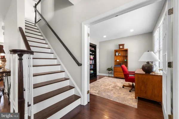 a view of entryway with wooden floor and stairs