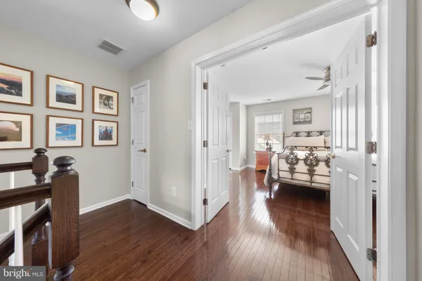 a view of a livingroom with furniture hardwood floor and a ceiling fan