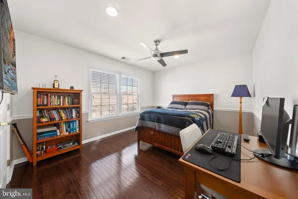a bedroom with furniture and a flat screen tv