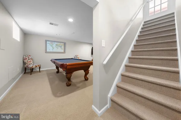 a room with furniture pool table and windows