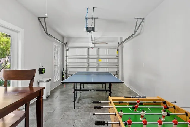 a living room with a table and chairs