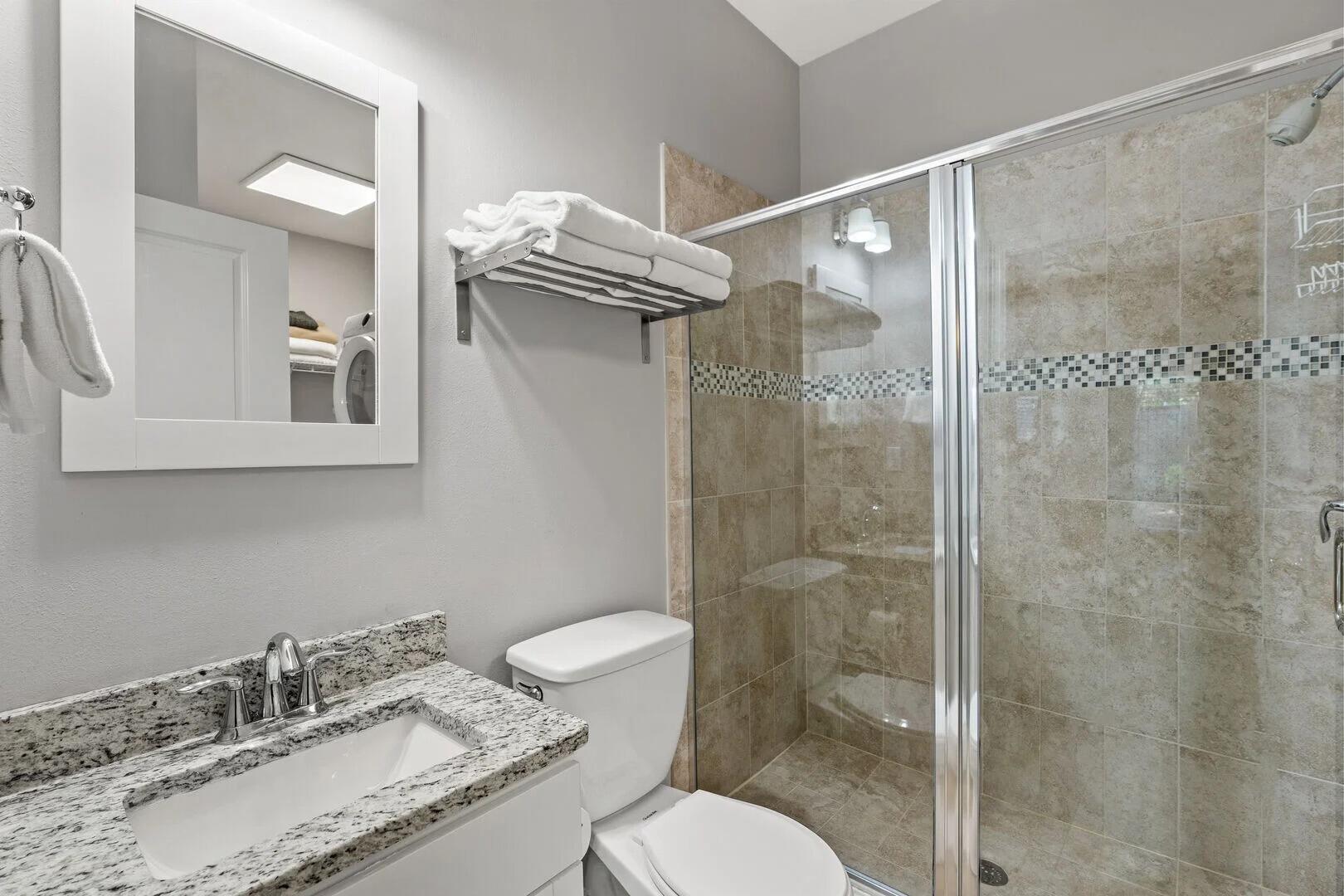 2059 Mack Bayou Road Santa Rosa Beach, FL 32459 - Photo 25 of 51 a bathroom with a granite countertop sink toilet a mirror and shower