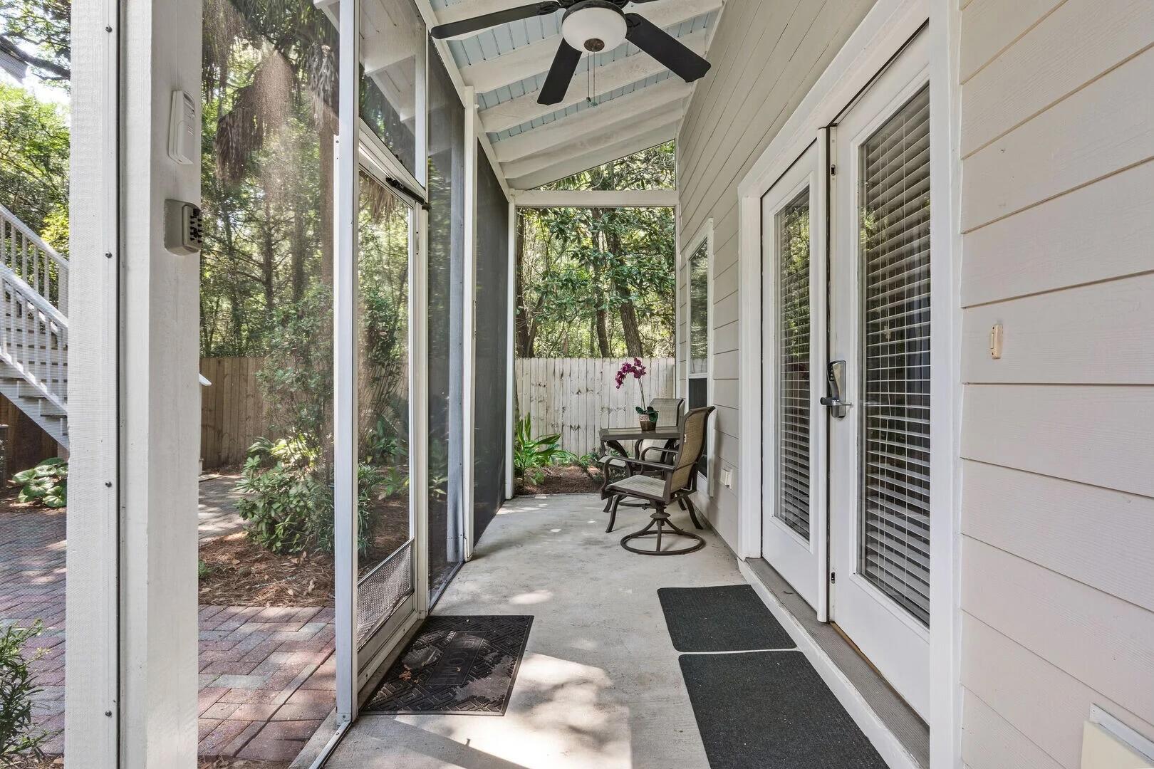 2059 Mack Bayou Road Santa Rosa Beach, FL 32459 - Photo 28 of 51 a view of a porch with chairs and entryway
