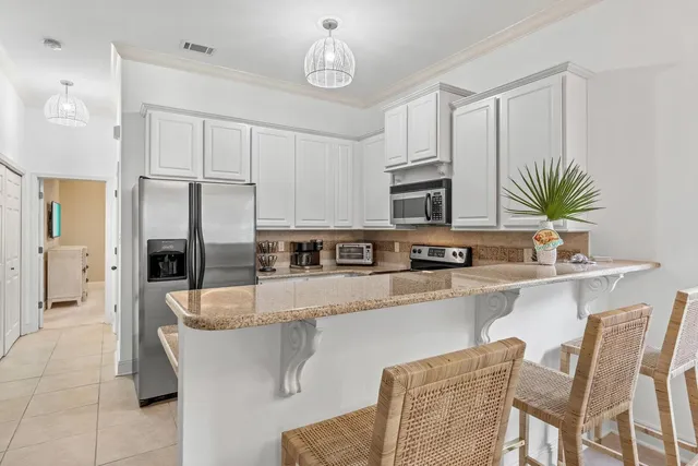 a kitchen with a sink and a lamp