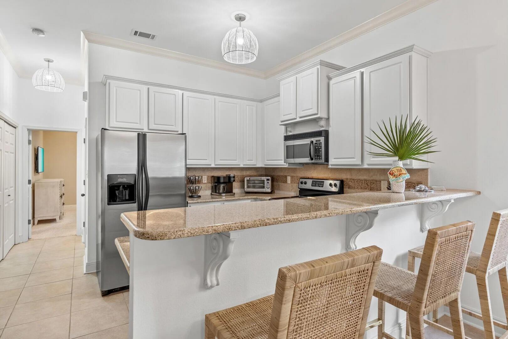 2059 Mack Bayou Road Santa Rosa Beach, FL 32459 - Photo 33 of 51 a kitchen with stainless steel appliances granite countertop a stove top oven a sink dishwasher a dining table and chairs with wooden floor