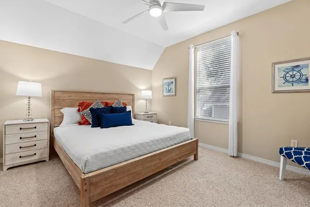 a bedroom with a bed dresser and a window