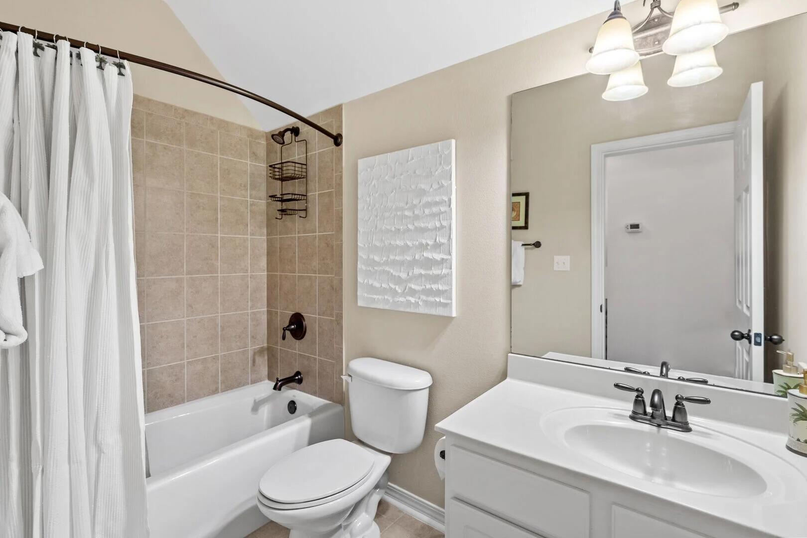 2059 Mack Bayou Road Santa Rosa Beach, FL 32459 - Photo 42 of 51 a bathroom with a sink a toilet a mirror a bathtub and shower