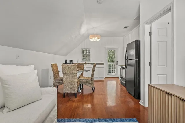 a kitchen with cabinets stainless steel appliances and a window