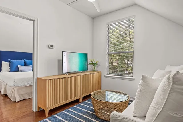 a bedroom with a bed and wooden floor