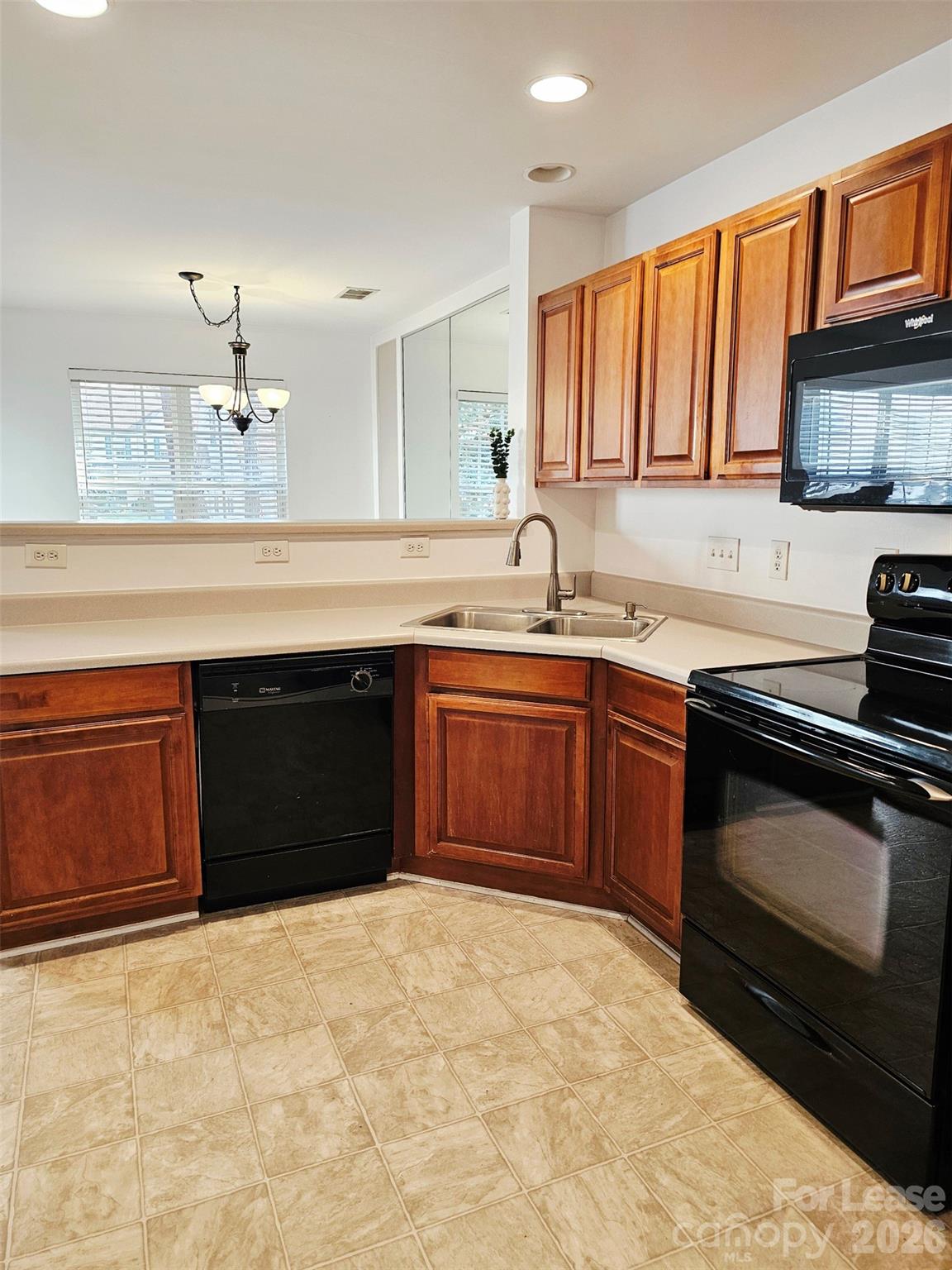 10609 Fuller Ridge Circle Charlotte, NC 28270 - Photo 11 of 29 a kitchen with a sink and a stove top oven