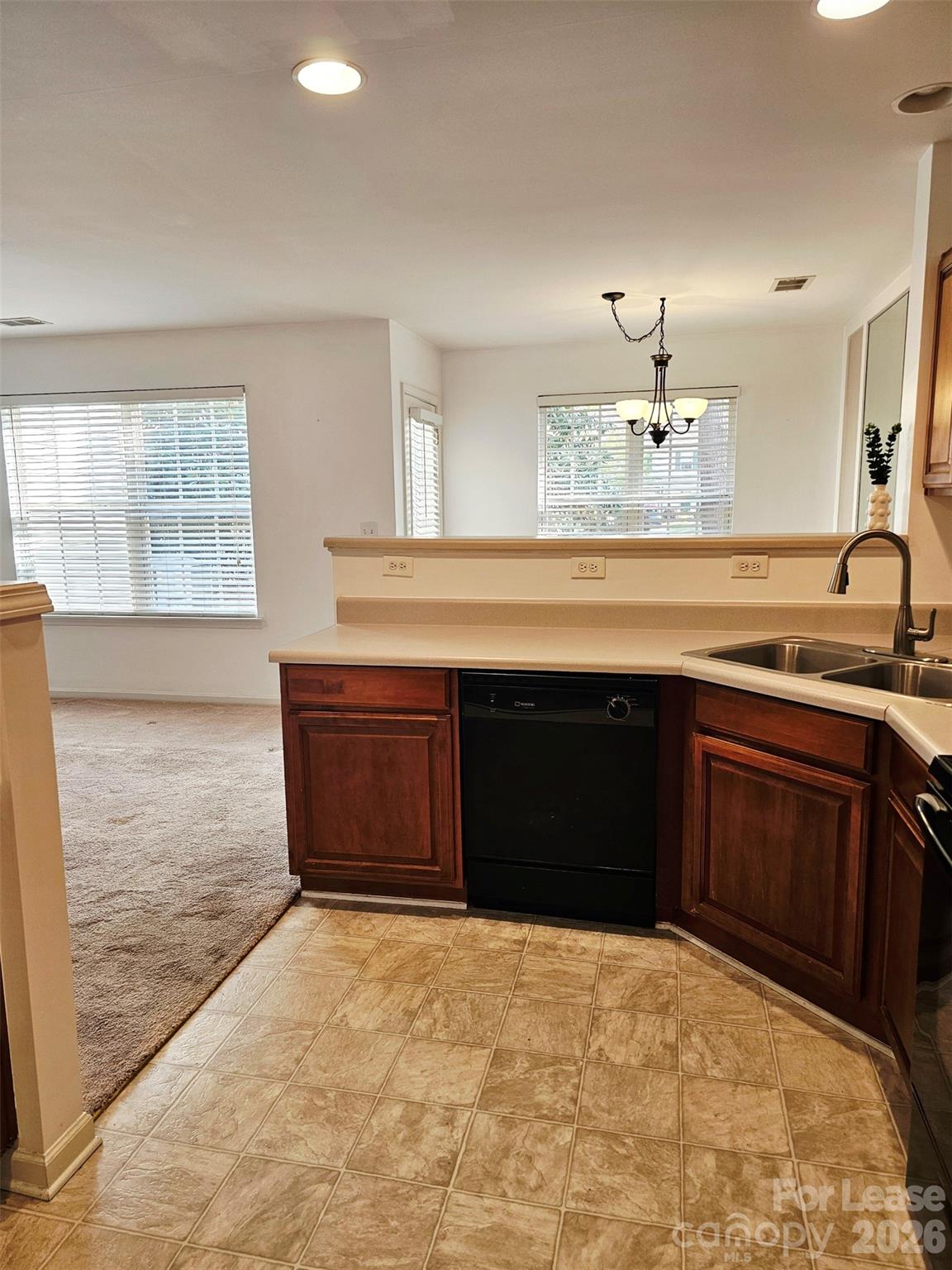 10609 Fuller Ridge Circle Charlotte, NC 28270 - Photo 13 of 29 a kitchen with a stove and a sink