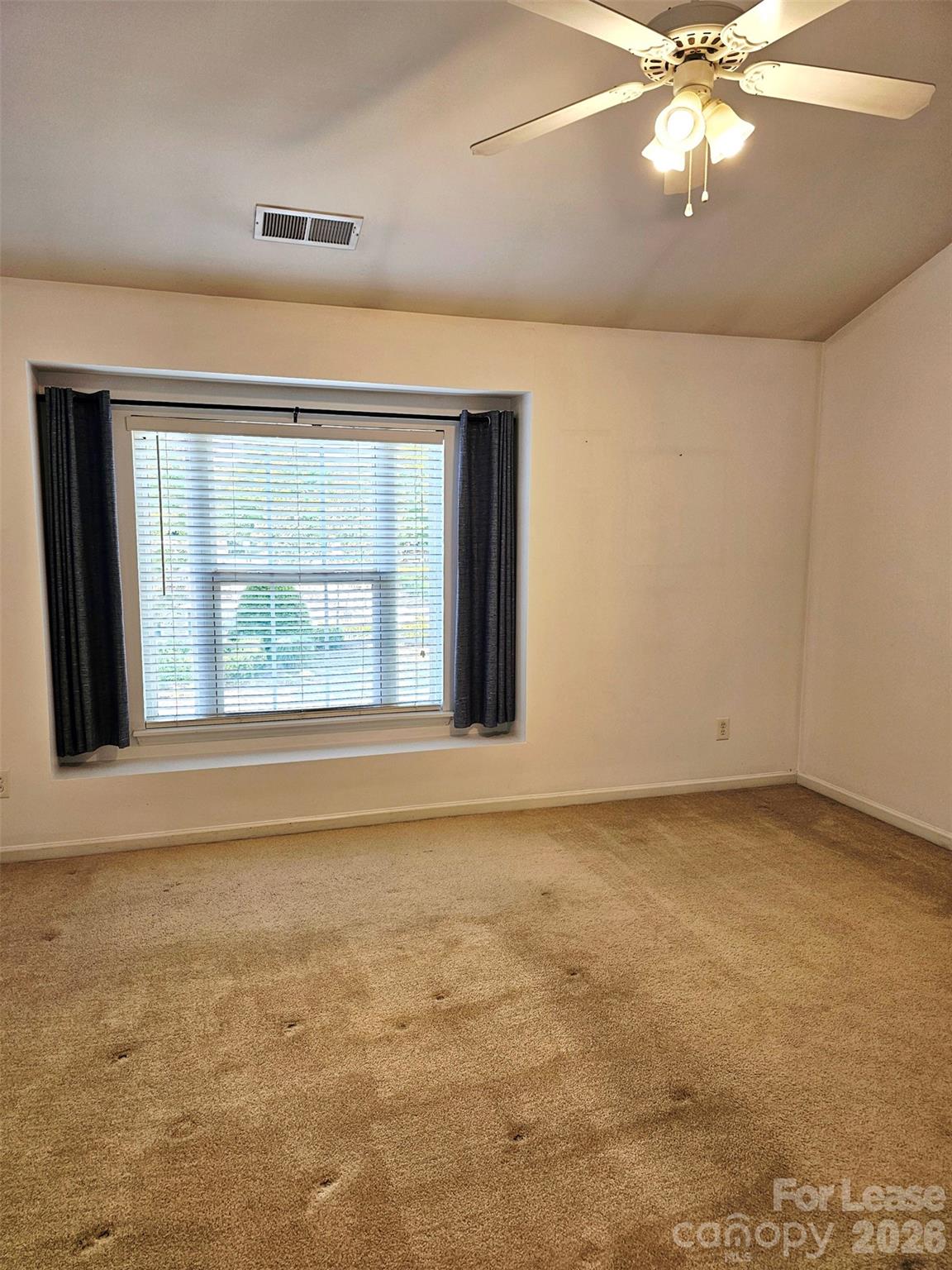 10609 Fuller Ridge Circle Charlotte, NC 28270 - Photo 16 of 29 an empty room with a window and a ceiling fan