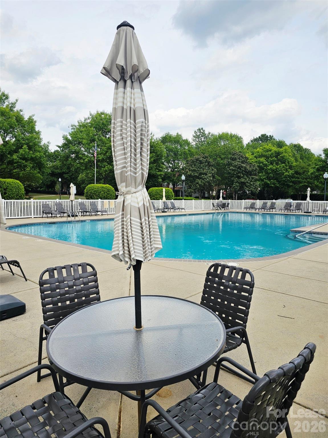 10609 Fuller Ridge Circle Charlotte, NC 28270 - Photo 29 of 29 a table and chairs sitting in the middle of a lake
