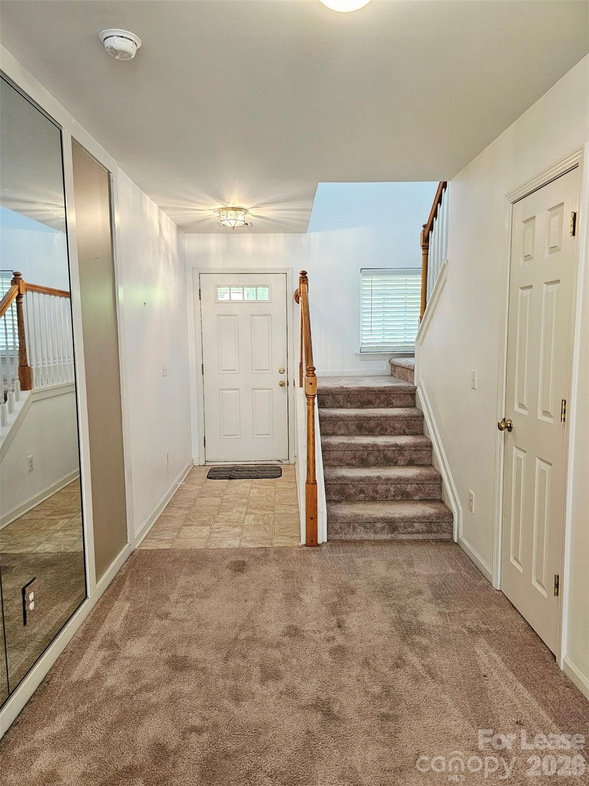 10609 Fuller Ridge Circle Charlotte, NC 28270 - Photo 4 of 29 a view of a hallway with staircase and white walls