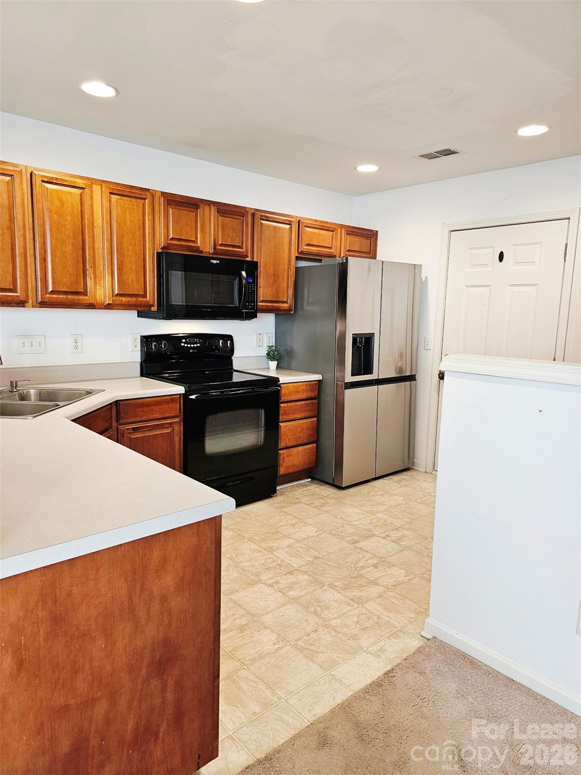 10609 Fuller Ridge Circle Charlotte, NC 28270 - Photo 9 of 29 a kitchen with stainless steel appliances kitchen island sink refrigerator and stove
