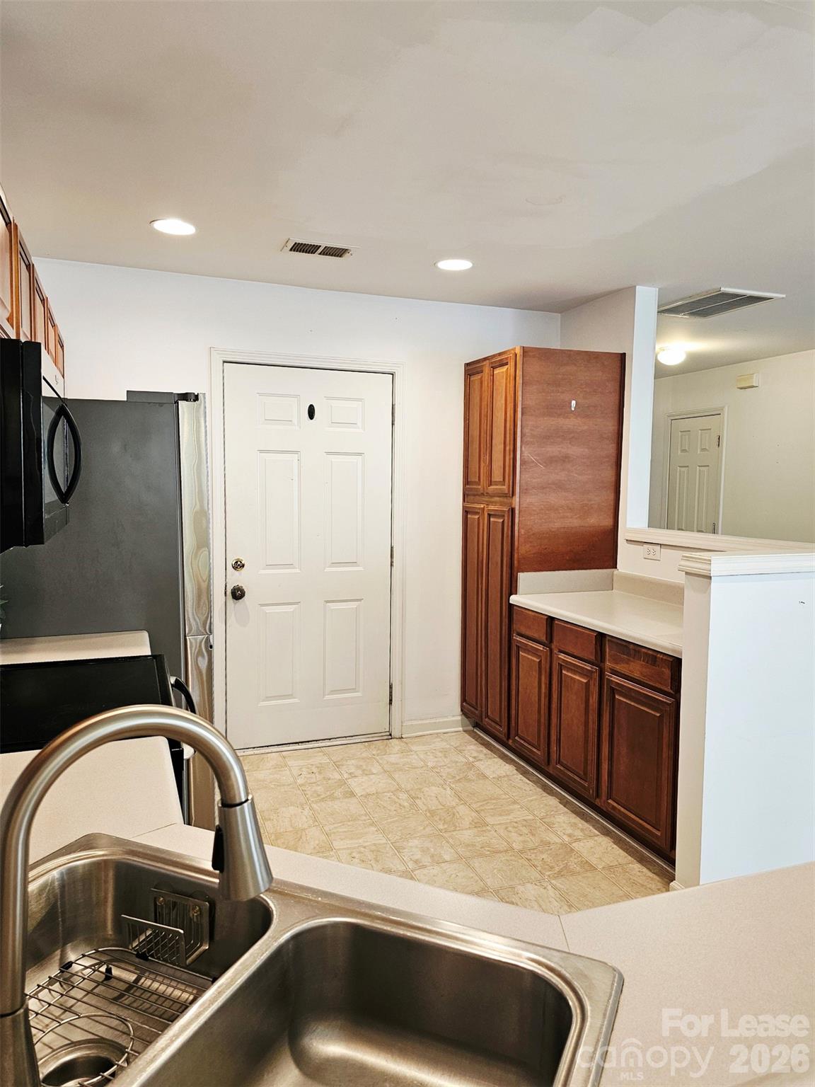 10609 Fuller Ridge Circle Charlotte, NC 28270 - Photo 10 of 29 a kitchen with a sink and a refrigerator
