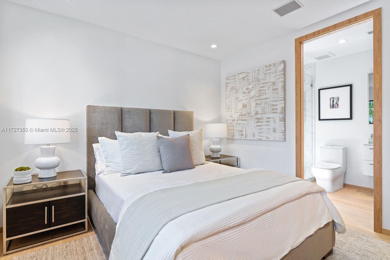 10 Pinta Road Miami, FL 33133 - Photo 13 of 28 a bedroom with a bed and a lamp on a dresser