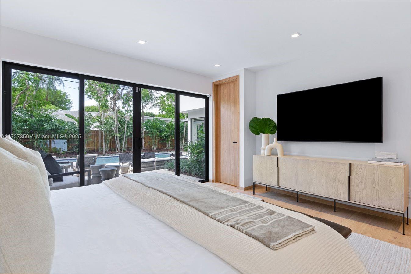 10 Pinta Road Miami, FL 33133 - Photo 19 of 28 a bedroom with a bed and a flat screen tv