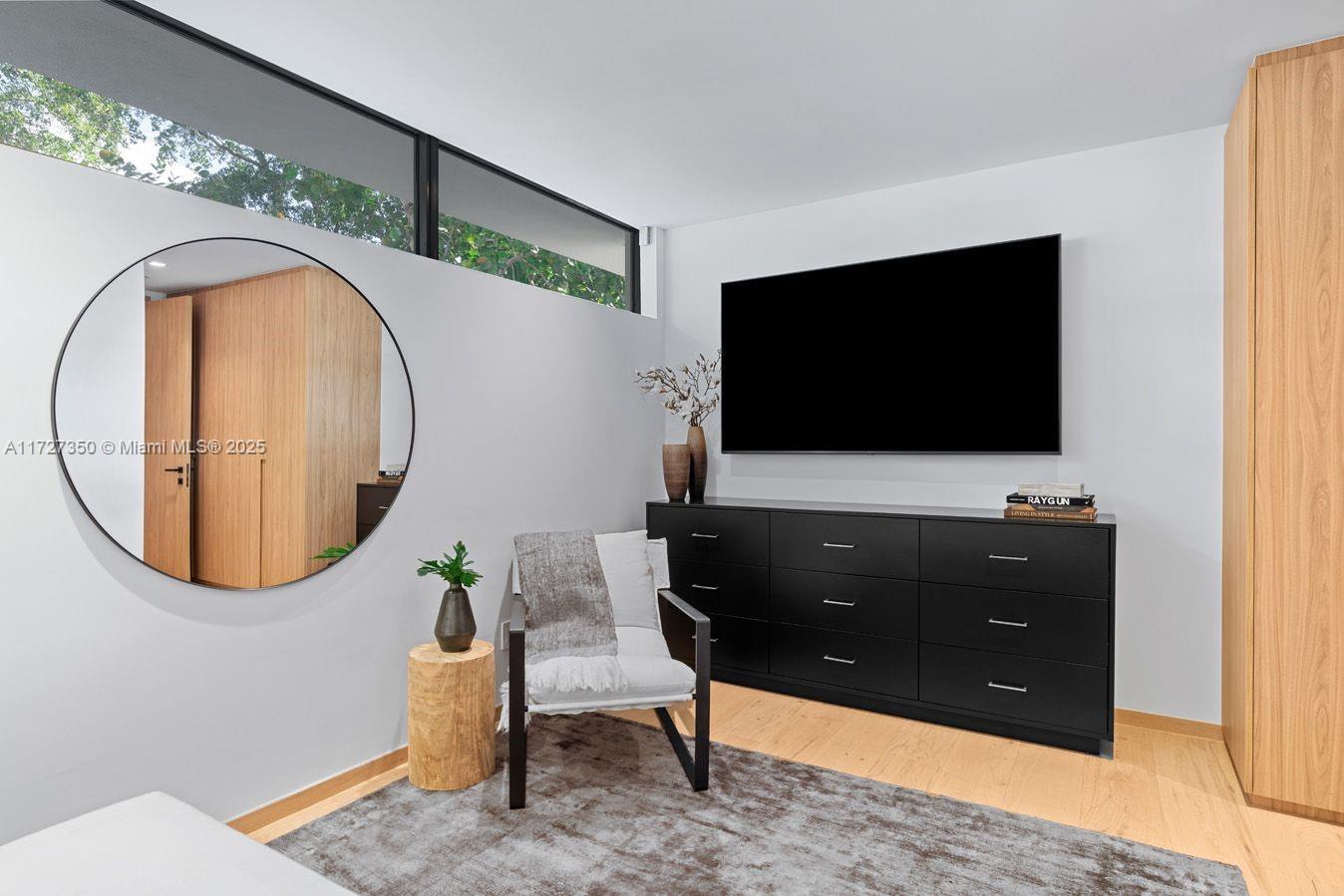 10 Pinta Road Miami, FL 33133 - Photo 27 of 28 a living room with a flat screen tv and a painting on the wall