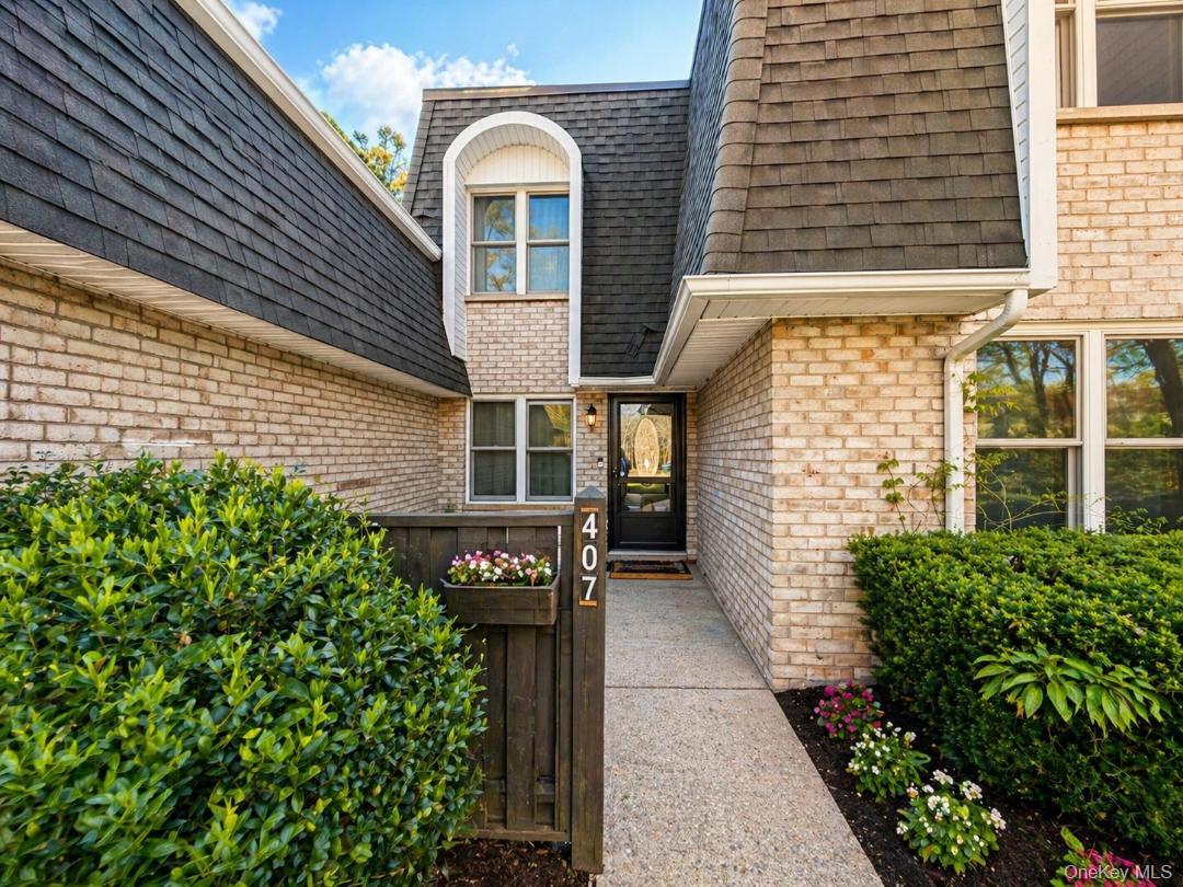 a front view of a house with plants