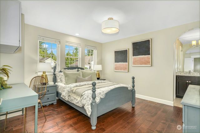 a bedroom with a bed and wooden floor