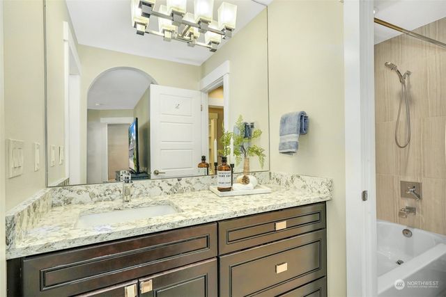 a bathroom with a granite countertop sink mirror and double