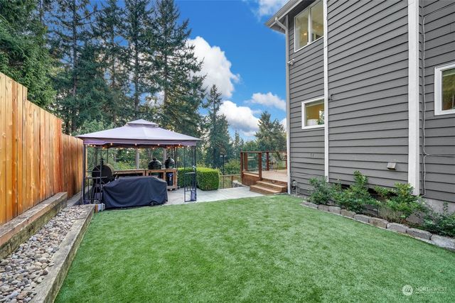a view of a house with a yard and sitting area