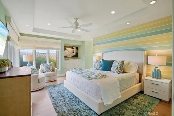 a large bedroom with a large bed and a chandelier