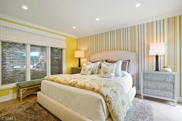 a bedroom with a large bed and a large window