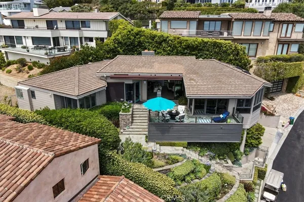 a aerial view of a house with yard and green space